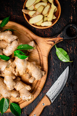 Wall Mural - Pieces of fresh ginger on a wooden plate. 