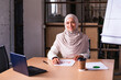 Beautiful middle-eastern businesswoman wearing traditional arab dress working in the office