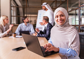 Wall Mural - Multiracial group of corporate businesspeople working in a business office - Multiethnic businessmen and businesswomen meeting in the office in Dubai, UAE