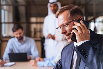 Wall Mural - Multiracial group of corporate businesspeople working in a business office - Multiethnic businessmen and businesswomen meeting in the office in Dubai, UAE