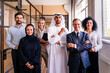 © oneinchpunch - Multiracial group of corporate businesspeople working in a business office - Multiethnic businessmen and businesswomen meeting in the office in Dubai, UAE