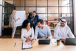 © oneinchpunch - Multiracial group of corporate businesspeople working in a business office - Multiethnic businessmen and businesswomen meeting in the office in Dubai, UAE