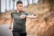 Fitness, smartwatch or man running for exercise, cardio training or workout in nature tracking health stats. Wellness, runner or sports athlete monitoring speed performance, heart rate or progress