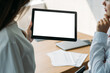 © golubovy - Online conference. Office women. Digital mockup. Unrecognizable female colleagues looking tablet computer with blank screen in light room interior.
