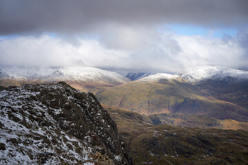 Canvas Print - The snow covered mountain summits of Dolly Wagon and Seat Sandal with the dark slabs of St Sunday Crags poking into the cloud from Langdale Pikes in the Cumbrian Lake District Mountains, England UK.