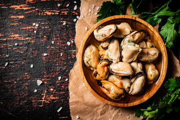 Canvas Print - A plate of pickled mussels on paper with parsley. 