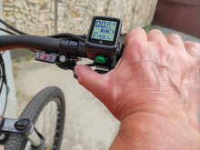 Male Hand On The Trigger Electronic Accelerator Of Electric Bike