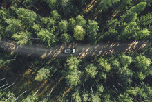 Aerial View Road With Car In Green Woods In Finland.