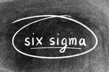 White chalk hand writing in word six sigma and circle shape on blackboard background