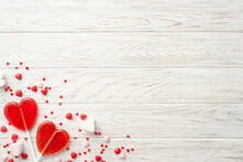 Valentine's Day Celebration Concept. Top View Photo Of Heart Shaped Lollipops And Candies On White Wooden Desk Background With Copyspace