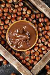 Wall Mural - Hazelnut butter on a wooden tray. 