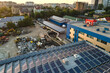 Blue photovoltaic solar panels mounted on building roof for producing clean ecological electricity at sunset. Production of renewable energy concept