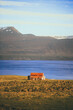 Beautiful scenic landscape in Iceland. The only old wooden house stands on the shore of the ocean, at the field.