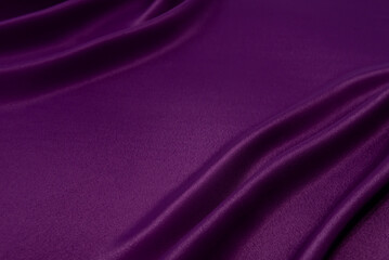 Black purple silk satin background. Copy space for text or product. Wavy soft folds on shiny fabric. Luxurious magenta background. Valentine, Christmas.Top view