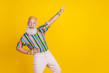 Sticker - Photo of pretty funky guy dressed striped shirt having fun pointing finger empty space isolated yellow color background