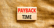 Payback time symbol. Concept words Payback time on wooden blocks. Beautiful canvas table canvas background. Business and payback time concept. Copy space.