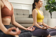 © anon - Couple diversity sporty people practicing .Asian active woman friend doing Yoga Pilates workout together at home.