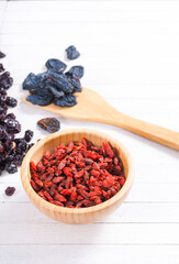 Canvas Print - dried goji, cherry, raisin and plum fruits on white wood