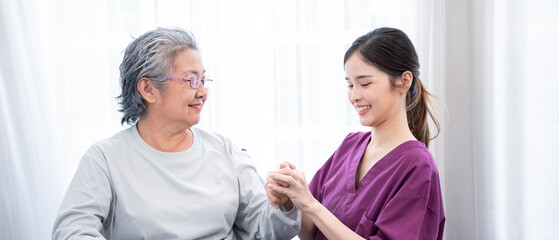 Medical staff taking and caregiver senior woman in Home. Home care concept.