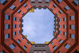 Fototapeta Niebo - Looking towards the sky from an octagonal courtyard in Berlin