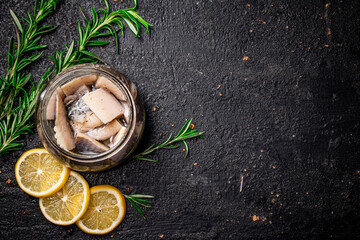 Poster - Pieces of salted herring in a jar with rosemary and lemon. 