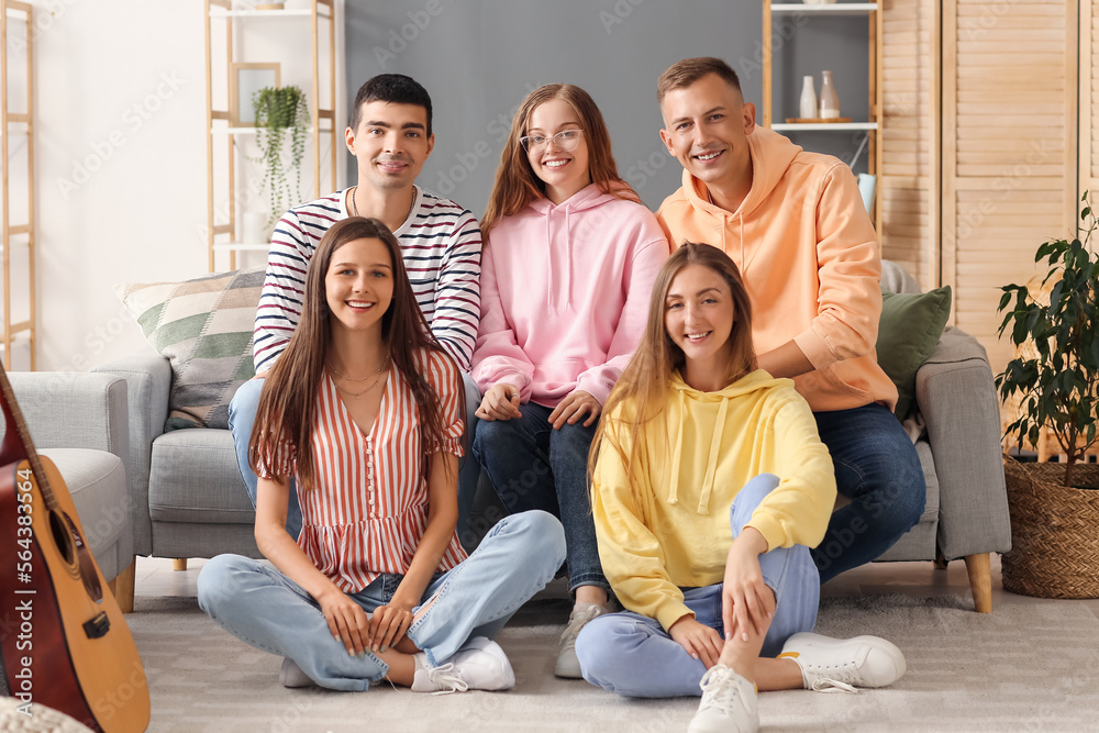 Group of friends resting in living room