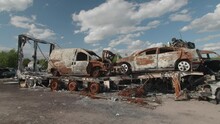 March, 2022. Bucha, Ukraine. Apocalyptic Scene Of Car Graveyard With Abandoned Landscape Around. Blown-up Cars For War Background Motion Wallpaper. High Quality 4k Footage