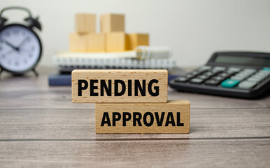 pending approval is shown on a conceptual photo using wooden blocks