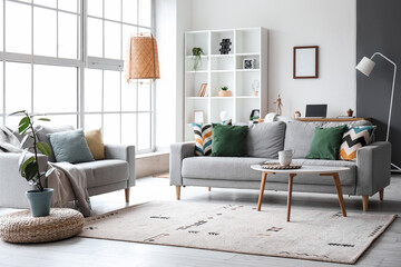 interior of modern living room with grey sofas, window and shelving unit