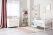 © Pixel-Shot - Stylish interior of children's room with baby bed