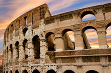 The Roman Colosseum At Sunset Highlighting The Beautiful Arches Of This Largest Ancient Amphitheater.