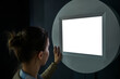 © zyabich - Woman looking at blank digital interactive white display wall at exhibition or museum with futuristic scifi interior. Mock up, future, copyspace, template, white screen, technology concept