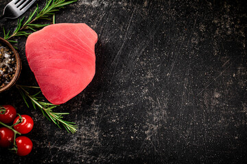 Wall Mural - Fresh raw tuna steak with tomatoes and rosemary. 