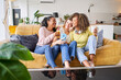 © CarlosBarquero - Indoor happy woman lifestyle portrait of three funny young female friends have fun and pretending smiling faces. Home party mood girls using mobile phone taking selfie photo. High quality photo