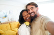 © CarlosBarquero - Happy people enjoying at home. Girlfriend and boyfriend taking smiling photo looking at camera. Couple in love. High quality photo
