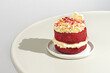 Valentine's day concept. Red velvet cake with white chocolate heart decoration. Hard shadows.