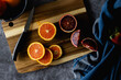 Cara cara and blood orange slices on a cutting board