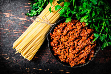 Poster - Bolognese sauce with parsley and dry pasta. 