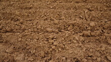 Closeup Of Macro View Of Red Dirt Or Mud Of Pile Soil From Agriculture Land. Soil Background.