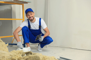 Poster - Professional worker with plaster and putty knife indoors