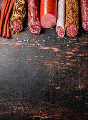 Wall Mural - Various salami sausage on the table in a row. 