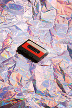 Old Cassette Tape On Crumpled Pink Background. Retro And Nostalgia Style. Vintage Music Concept. Copy Space. Y2K Design Trend, 2000 Year