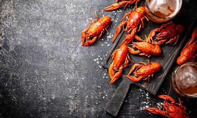 Canvas Print - Boiled crayfish with beer on a cutting board. 