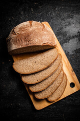 Sticker - Sliced rye bread on a cutting board.