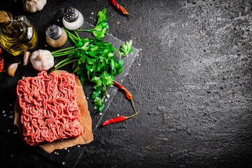 Sticker - Minced meat on a stone board with parsley and garlic. 