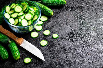 Wall Mural - Full glass bowl of chopped fresh cucumbers. 