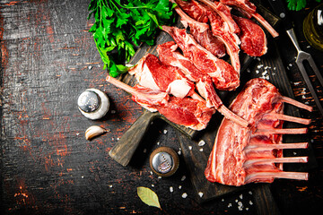 Wall Mural - Raw rack of lamb with parsley on a cutting board. 