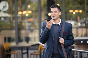 Poster - Happy, loud speaker or communication man with phone call for contact us, telemarketing or networking in London street. Smile, 5g network or employee with smartphone for strategy or success planning