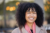 Fototapeta Londyn - Happy woman, portrait and city travel with a smile while outdoor on London street with freedom. Face of young black person with natural afro hair, beauty and fashion style during student holiday walk
