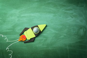 Poster - Business project launch, startup and creative idea concept with taking off bright graphic rocket on green blackboard background. 3D rendering